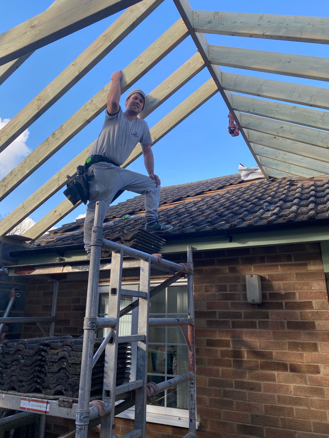 Carpenter working on roof beams